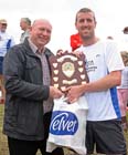 Look North weatherman Paul Mooney presents winner Steve Rankin (Sunderland Stroller) with the Prudhoe Miners Race Trophy.